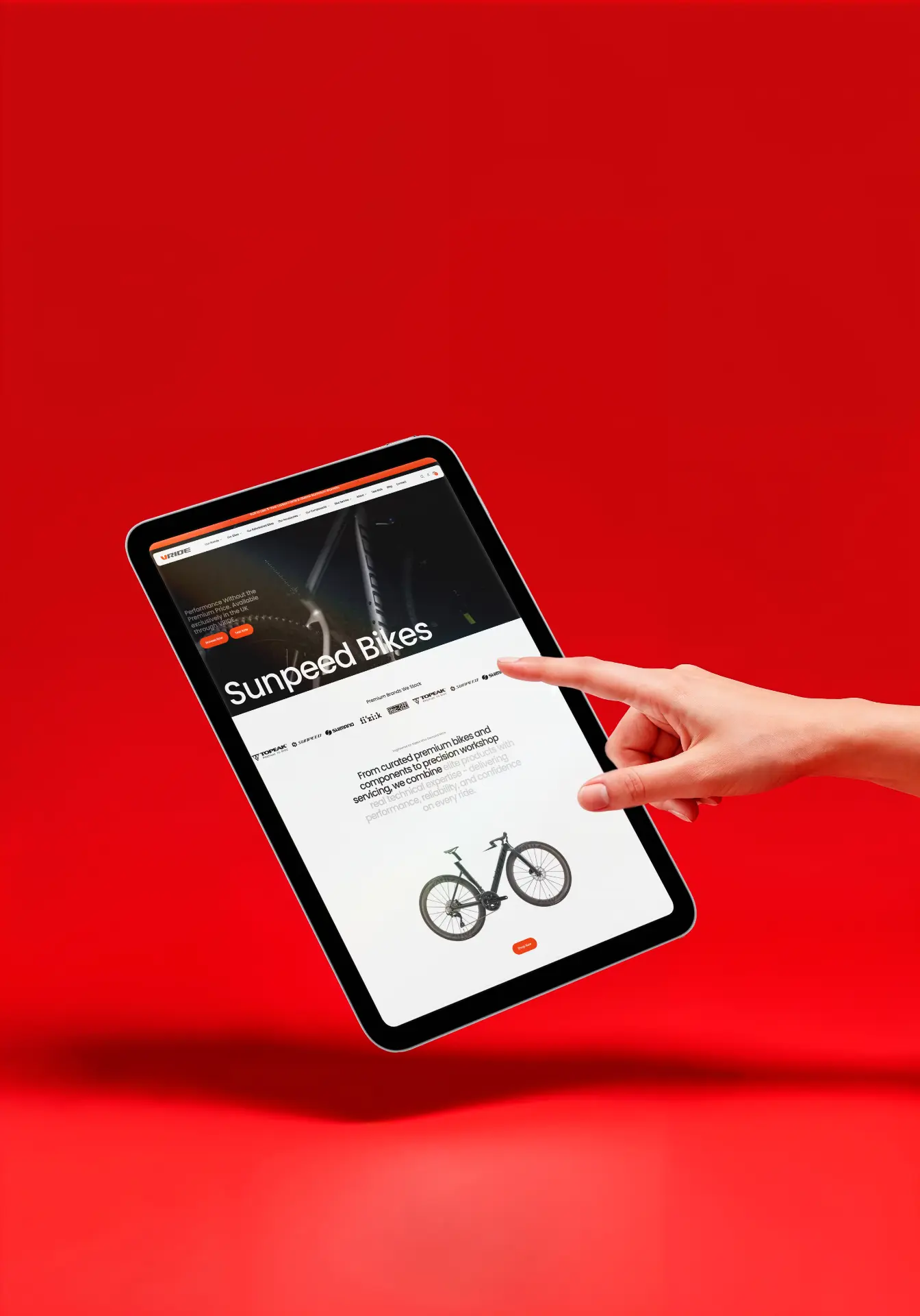 Cycling site on a tablet against a red backdrop