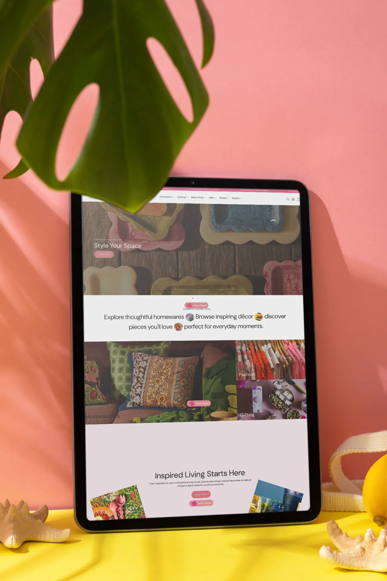 Homewares site on a tablet against a pink wall